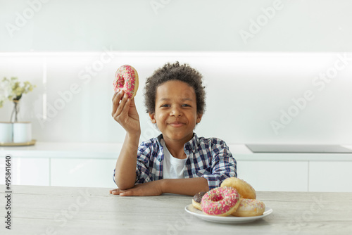 Little boy eating donut