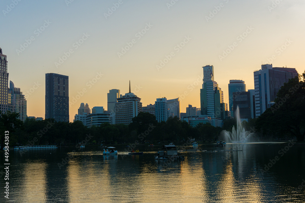 Fototapeta premium Silhouette office building sunset light in public park
