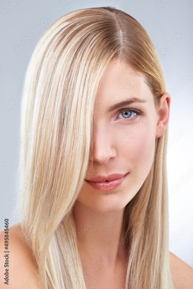 Blonde and beautiful. Studio portrait of a young woman with long blonde hair. Blonde and beautiful. Studio portrait of a young woman with long blonde hair.