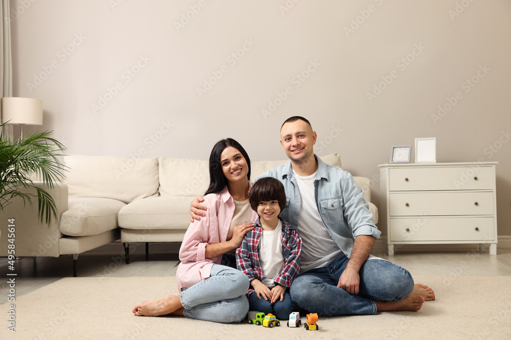 Happy family sitting on floor at home Happy family sitting on floor at home