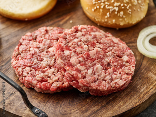 Raw mince meat cutlet, ground beef and pork with bun.