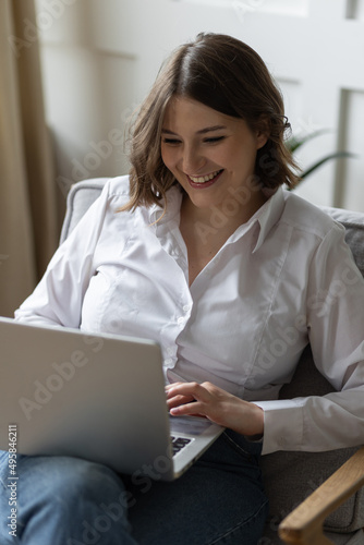 Young beautiful smiling woman using laptop. Concept of freelance job  home office. Female using technology for learning  shopping  e-commerce  communication  social media