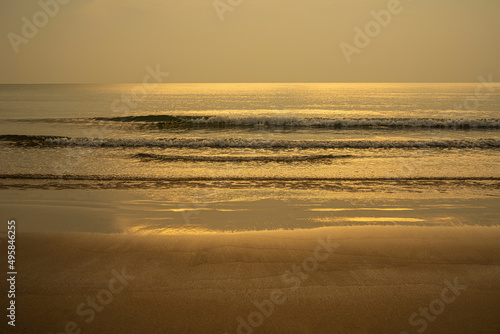 Closeup soft wave of the sea on the sandy beach.