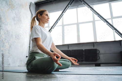 Meditation sitting in a room in the lotus position, hands chinmudra folded fingers, girl practices yoga, calm the mind, relax the body, meditation room, Zen space