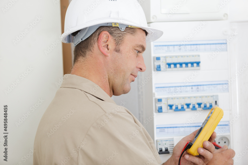 electrician testing circuit breaker cabinet with multimeter electrician testing circuit breaker cabinet with multimeter