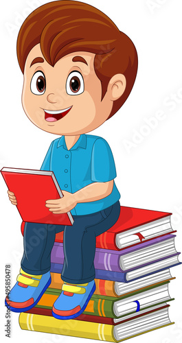 Cartoon little boy sitting and holding a book on a pile of books