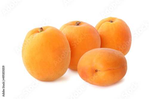 Several big flat ripe apricots isolated on white