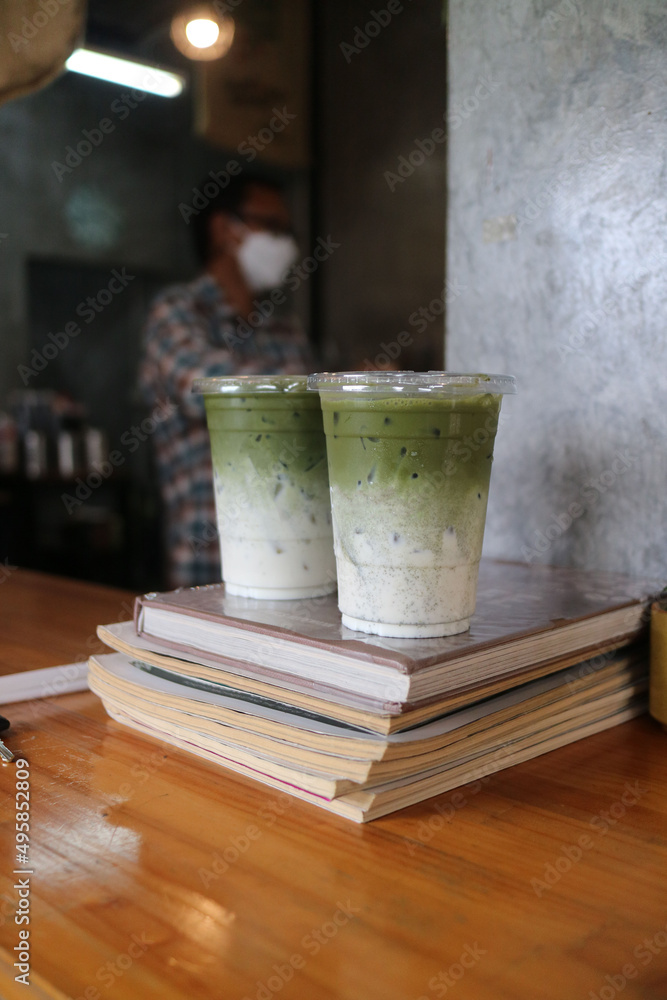 Matcha, green tea - Barista pouring Matcha to a glass of ice with traditional japanese matcha tools Matcha, green tea - Barista pouring Matcha to a glass of ice with traditional japanese matcha tools