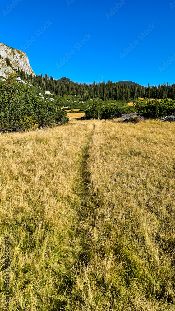 Hiking trail leading to a remote mountain hut with panoramic view on the mountain peaks of the Hochschwab Region in Upper Styria, Austria. Hinterer Polster, Alps in Europe. Wilderness. Concept freedom