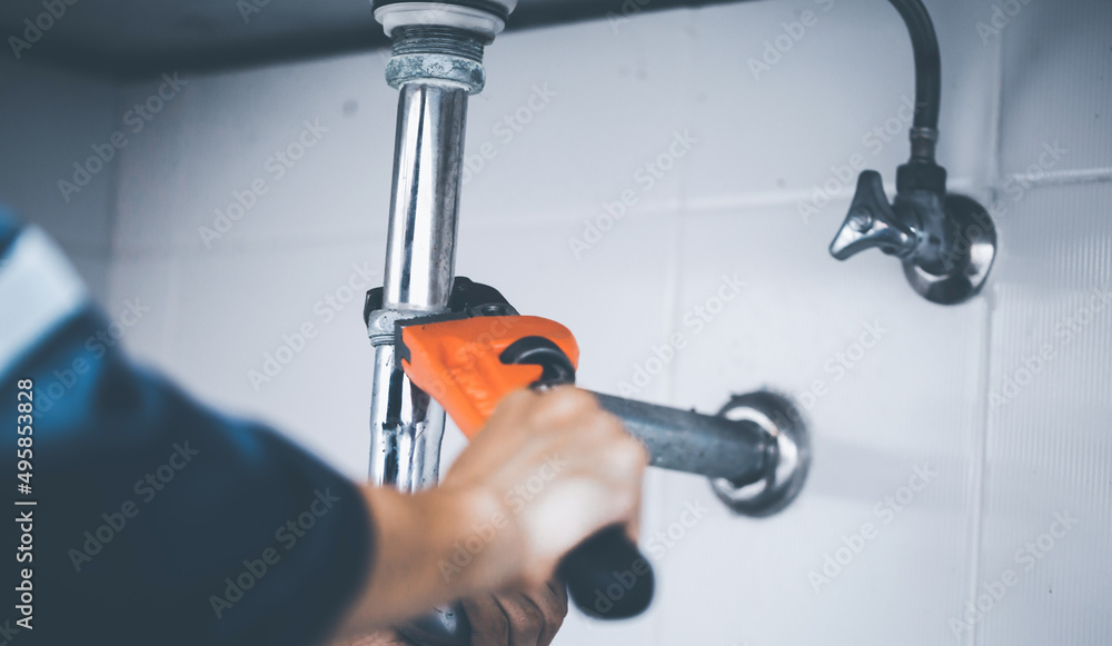 plumber at work in a bathroom, plumbing repair service, assemble