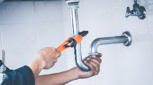 plumber at work in a bathroom, plumbing repair service, assemble