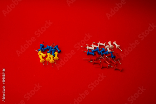 Pushpins  country flags  war on a red background