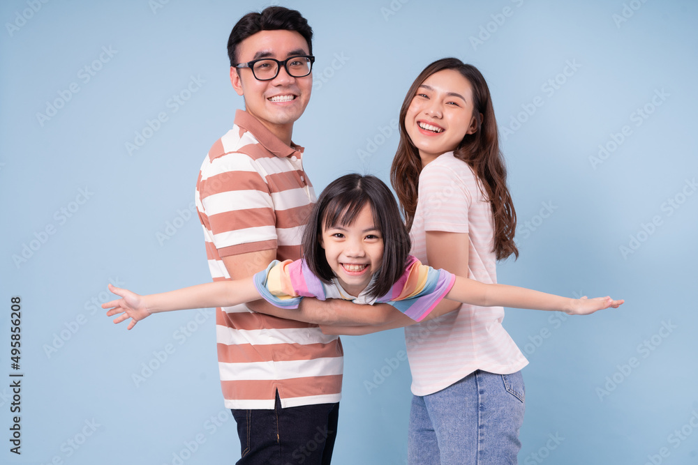 Portrait of young Asian family on background Portrait of young Asian family on background