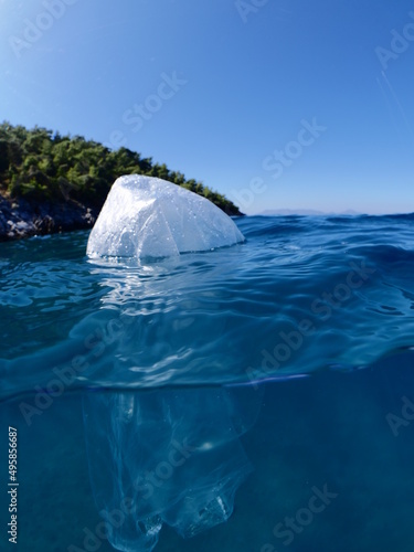 split shot of plastic bag underwater ocean pollution global waste like iceberg