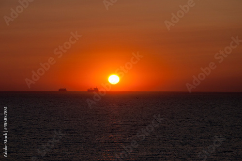 sundown sky and sea with ship on horizon  summer