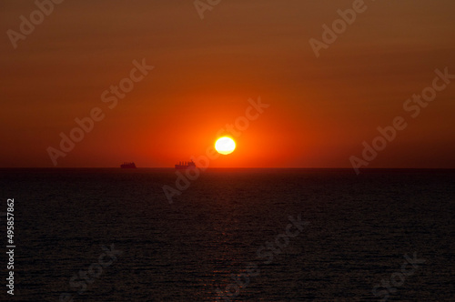 sundown sky and sea with ship on horizon  bali