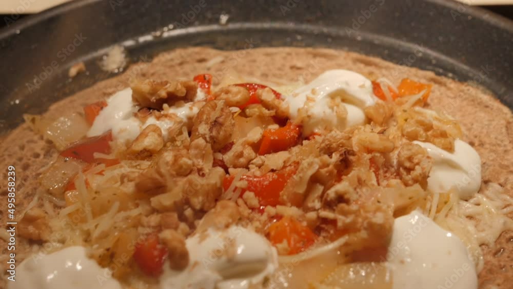 French Buckwheat Crepe With Toppings Cooking On A Non-stick Pan. close up French Buckwheat Crepe With Toppings Cooking On A Non-stick Pan. close up
