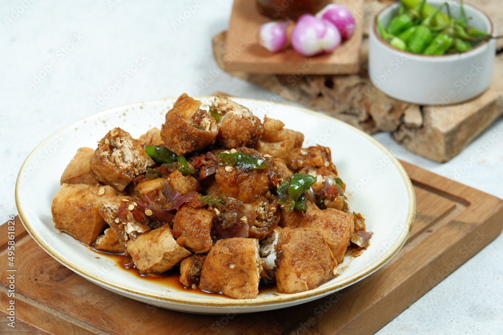 tahu gejrot , is a typical food from Cirebon, Indonesia.Traditional street food dish of fried bean curd with crushed shallot and green chili in sweet soy sauce tahu gejrot , is a typical food from Cirebon, Indonesia.Traditional street food dish of fried bean curd with crushed shallot and green chili in sweet soy sauce