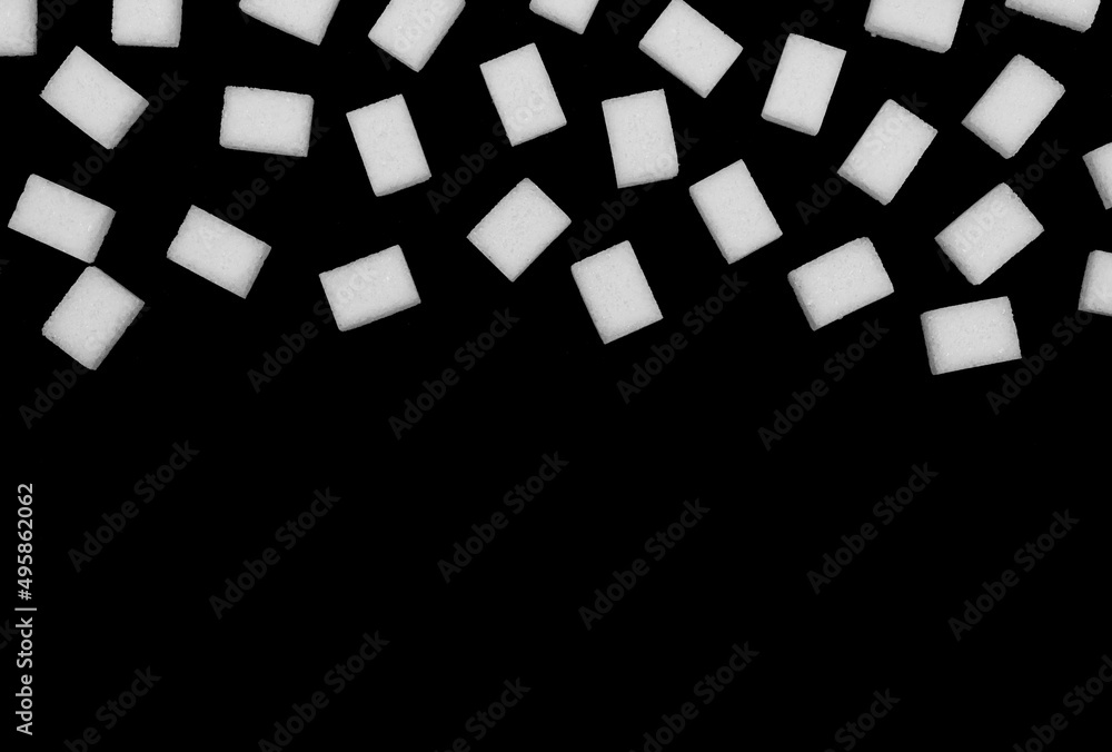 Obraz premium Natural white sugar cubes isolated on black background