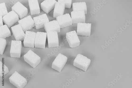 Natural white sugar cubes isolated on gray background