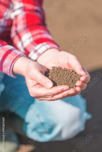Female farmer holding soil in cupped hands