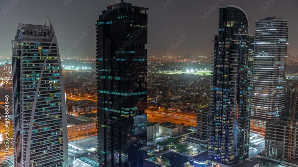 Tall residential buildings at JLT aerial night timelapse, part of the Dubai multi commodities centre mixed-use district. Tall residential buildings at JLT aerial night timelapse, part of the Dubai multi commodities centre mixed-use district.