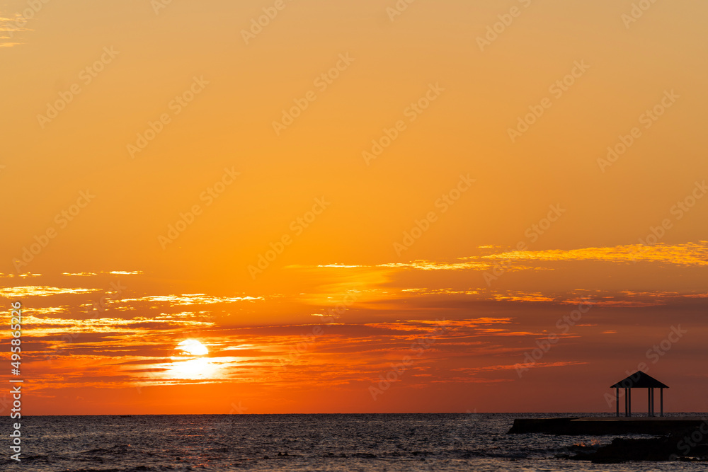 Incredibly beautiful best orange sunset or sunrise on the Caribbean Sea in the Dominican Republic. Sea, sky with clouds and horizon