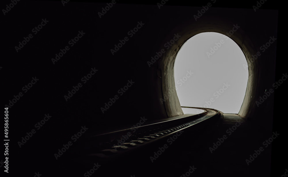 Inside the railroad tunnel and railways with natural light at the end. Light at the end of the tunnel, Lights and shadows, Concept of achieving your goals, Copy space, No focus, specifically.