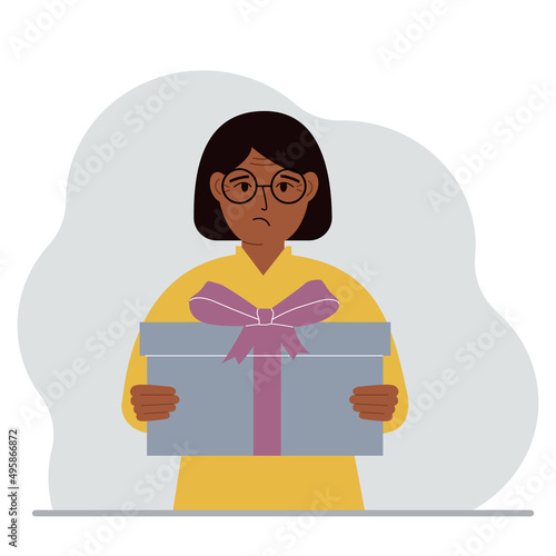 A sad woman holds a large gift box with a bow in his hands. Vector