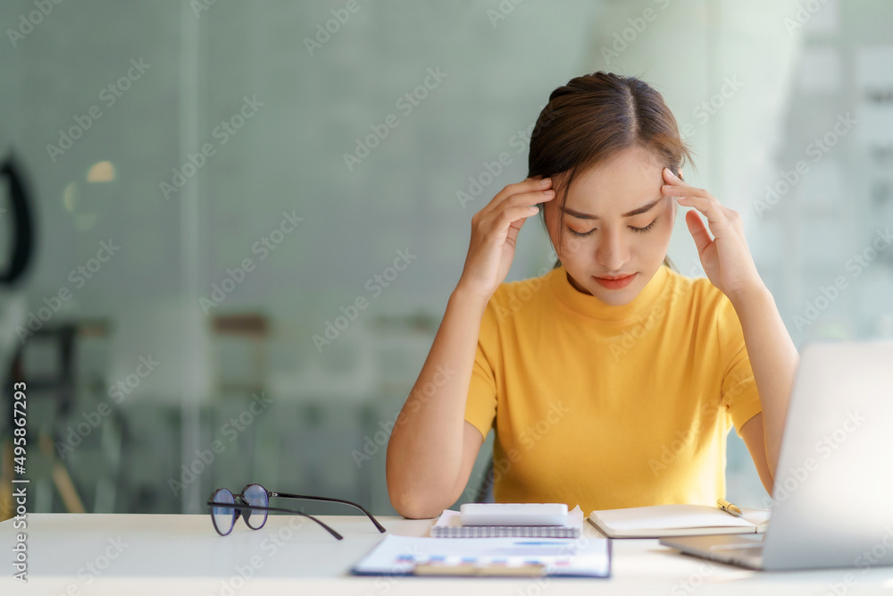 Asian businesswoman who is overworked and stressed from working at the office. Asian businesswoman who is overworked and stressed from working at the office.