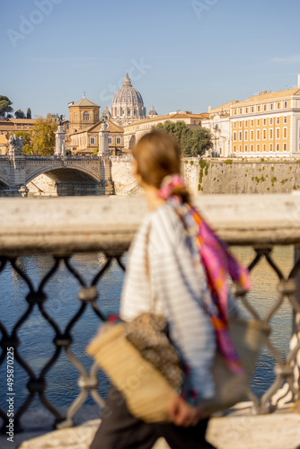 Photography Woman walking on the bridge in Rome on a sunny autumn day
