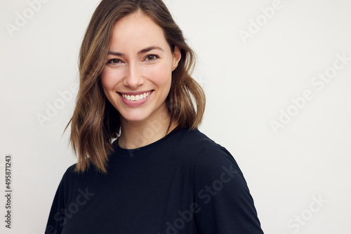 Slika na platnu Portrait of beautiful natural brunette woman, smiling and looking in camera with white teeth