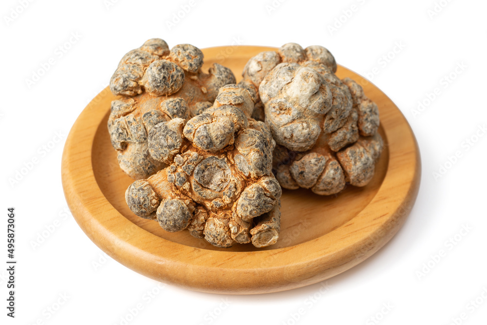 Dried notoginseng roots in the wooden bowl, isolated on the white background. Dried notoginseng roots in the wooden bowl, isolated on the white background.