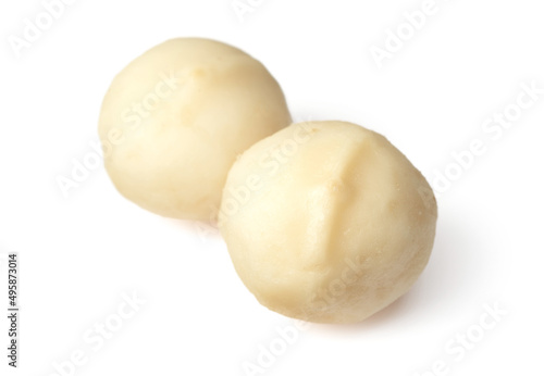 Unshelled macadamia nuts isolated on white background.