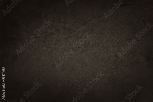 Dark brown slate stone wall texture in natural pattern with high resolution for background and design art work.