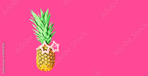 Pineapple with pink sunglasses on pink background, colorful ananas