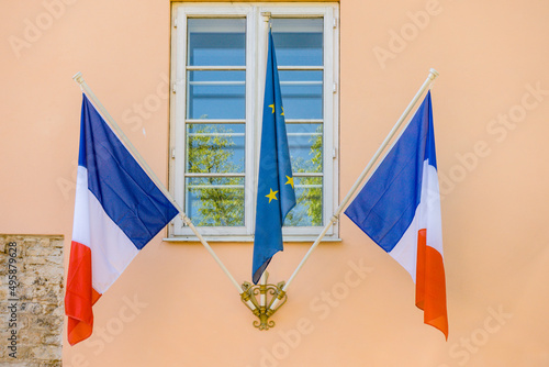 European Union and French flag on classical building wall photo