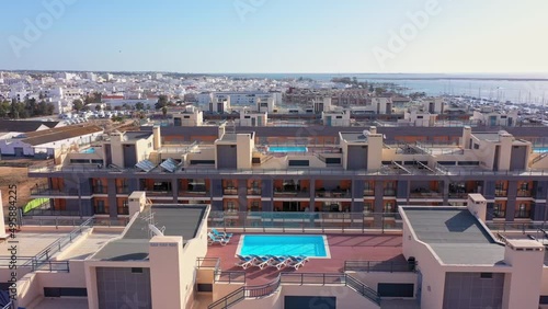Aerial view of the urban area of portugal in the south of houses with modern infrastructure swimming pools overlooking the sea. Southern city of Portugal Olhao.