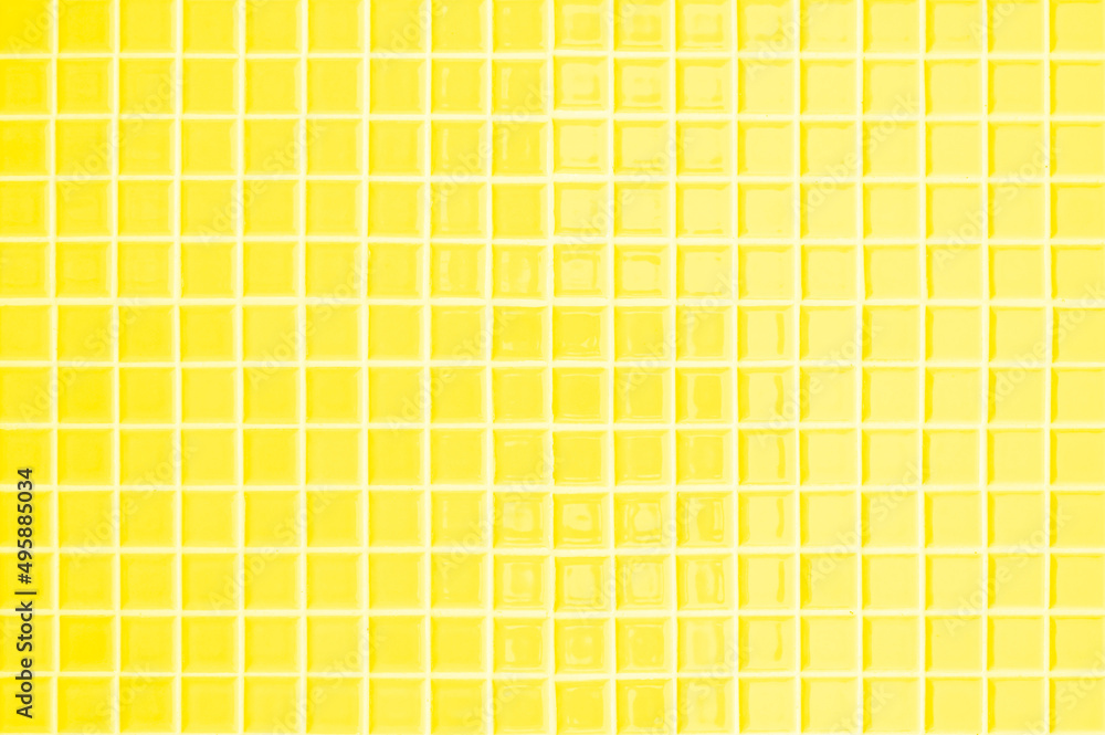 Yellow ceramic wall and floor tiles mosaic abstract background. Design geometric wallpaper texture decoration. Yellow ceramic wall and floor tiles mosaic abstract background. Design geometric wallpaper texture decoration.