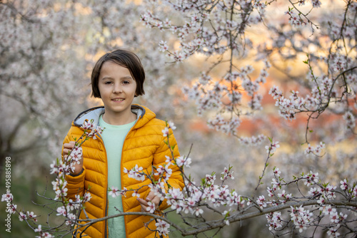 Canvas Print Happy child, preteen boy, visiting spring park in Prague, walking at sunset