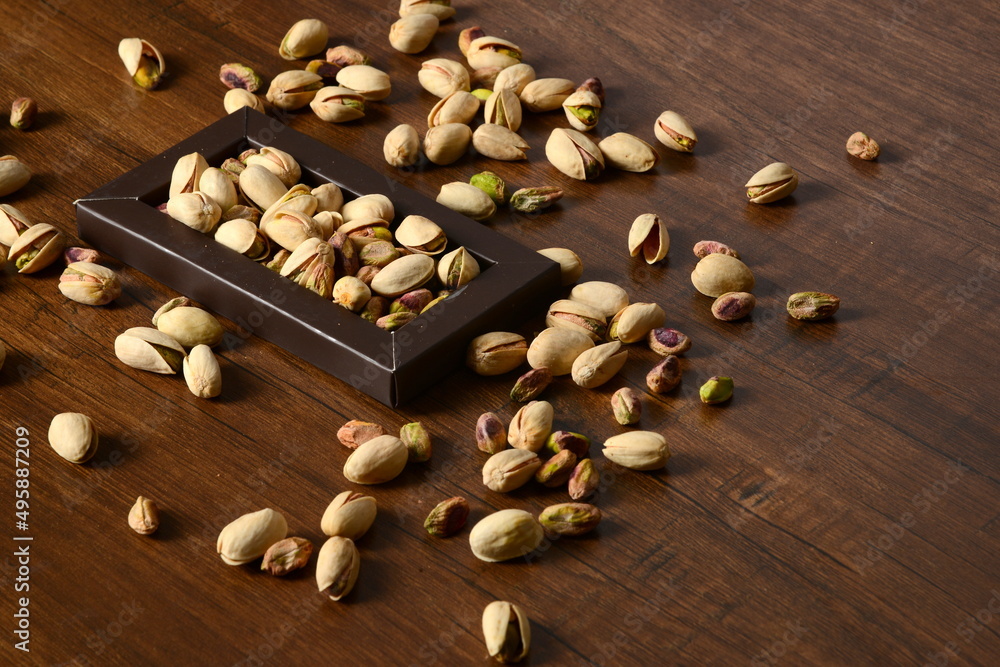 Fresh almonds in the wooden bowl, Organic almonds, almonds border white background, Almond nuts on a dark wooden background. Healthy snacks. Top view. Free space for text. Fresh almonds in the wooden bowl, Organic almonds, almonds border white background, Almond nuts on a dark wooden background. Healthy snacks. Top view. Free space for text.