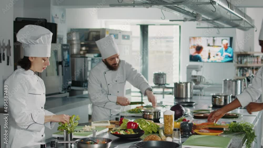 Authentic chef using rosemary plant leaves to cook tasty greens dish with vegetables and organic authentic ingredients. Woman making aromatic food recipe in professional kitchen, gourmet dish.