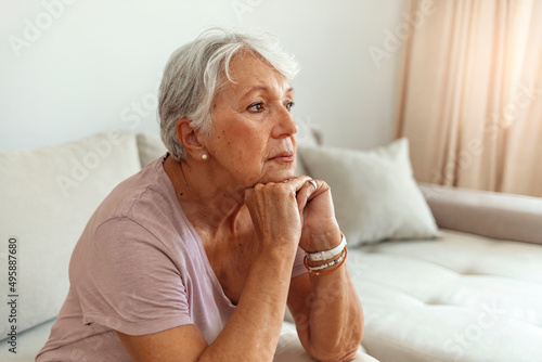 Cropped shot of a senior woman looking worried with her hands clasped together at home. Shot of a melancholy senior woman sitting alone in her room at home.