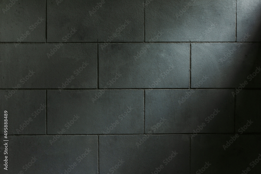 Close-up of a block wall and slightly bright lights. Image for background with copy space Close-up of a block wall and slightly bright lights. Image for background with copy space