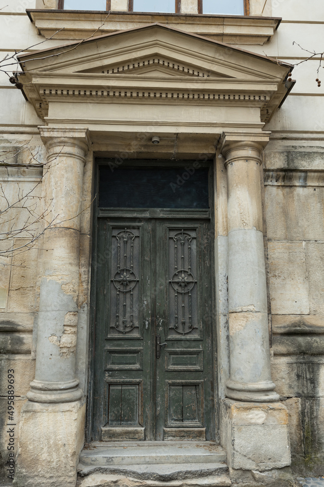 Old wooden door in historical building, Bucharest, Romania