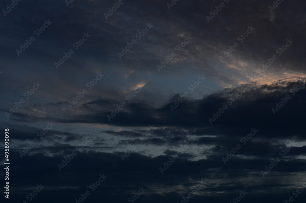 Storm Clouds Over a Lake Beach at Sunset Storm Clouds Over a Lake Beach at Sunset