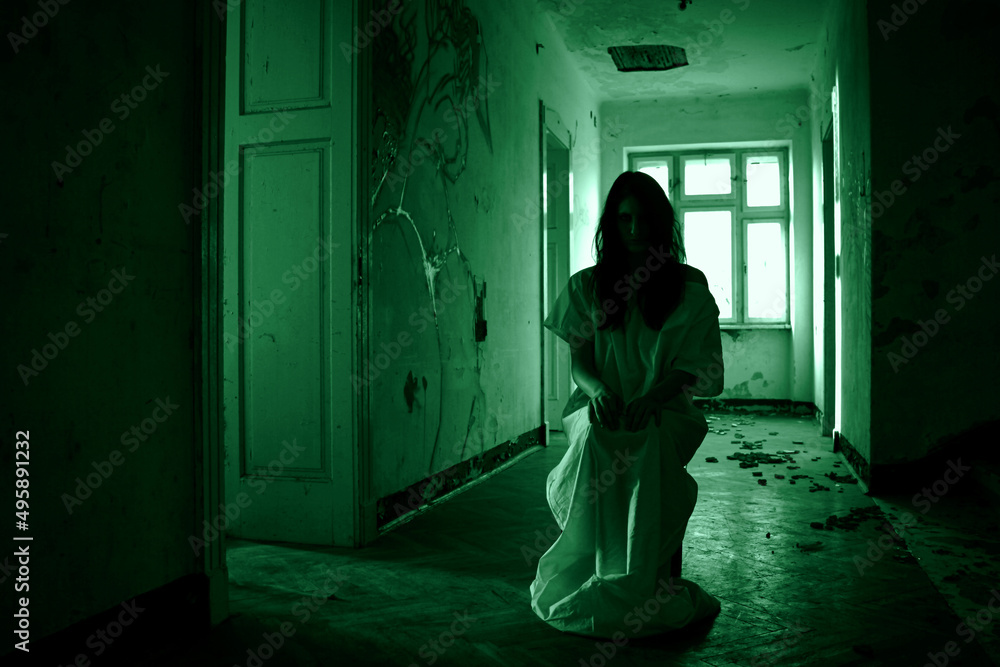 Horror scene of a scary woman in dark hallway