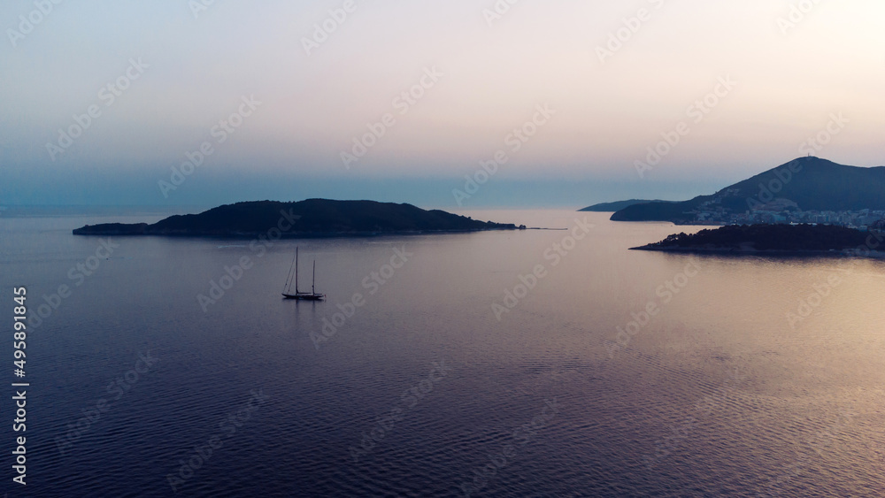 Sailing boat in the Mediterranean sea during scenic sunset.Luxury yacht and cruise holiday. Aerial view of sailboat
