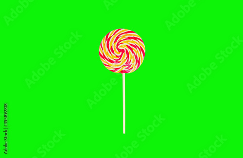 Close up colorful lollipop caramel on stick on green background