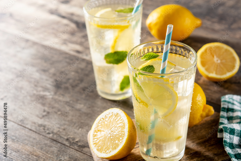 Glass of fresh lemonade on wooden table. Copy space Glass of fresh lemonade on wooden table. Copy space